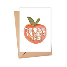 Load image into Gallery viewer, The "You are a Peach Thank You Card" from R is for Robo features a charming illustration of a peach with lush green leaves. The text on the peach says, "Thank you, you are a peach." This delightful card, accompanied by a brown envelope, offers the perfect opportunity to add a personal touch to your handwritten note.
