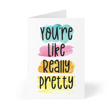 Load image into Gallery viewer, The "You're Like Really Pretty Friendship Card" by R is for Robo is beautifully displayed against a white background. It showcases colorful text on watercolor brush strokes, with the message "You're Like Really Pretty" in black font. The brush strokes in teal, pink, orange, and yellow create the impression of a personalized handwritten note.