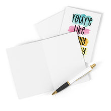 Load image into Gallery viewer, A blank greeting card is open beside a charming "You're Like Really Pretty Friendship Card" from R is for Robo, featuring colorful text. A black and white pen with gold accents is poised on the blank card, ready for a handwritten note.