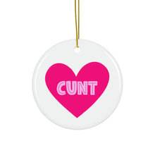 Load image into Gallery viewer, The &quot;Cunt Christmas Ornament&quot; by R is for Robo is a round white decoration featuring a large pink heart with the word CUNT written in bold, white capital letters. This cheeky ornament, complete with a gold string, makes for a humorous holiday gift that&#39;s sure to bring laughter.
