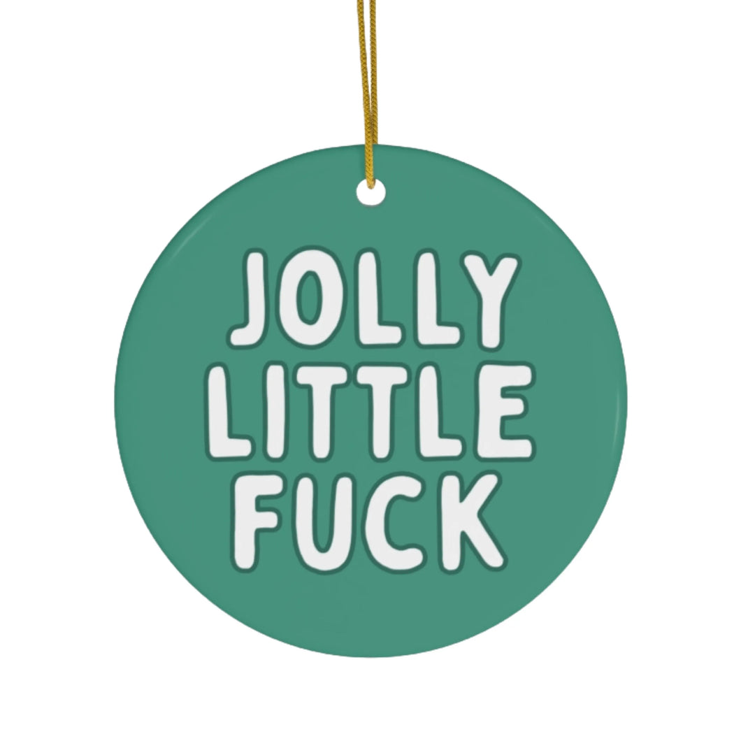 Adding a touch of sassy holiday decor, the Jolly Little Fuck Funny Christmas Ornament by R is for Robo is a round green piece with bold white text. It's perfect for those who appreciate cheekiness in their festive celebrations, hanging elegantly by a thin yellow string.