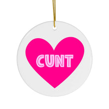 Load image into Gallery viewer, Introducing the &quot;Cunt Christmas Ornament - Funny Gifts for Women&quot; by R is for Robo: This round, white ornament features a vibrant pink heart at the center with the word CUNT boldly displayed in white letters. Hanging from a delicate golden string, it&#39;s perfect for adding a touch of cheeky humor to your holiday decor.
