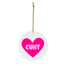 Load image into Gallery viewer, A round Christmas ornament from R is for Robo, featuring a pink heart in the center with bold white text spelling &quot;CUNT.&quot; This humorous ornament hangs from a thin gold string, making it an ideal sweary gift for those who appreciate an inappropriate holiday touch.
